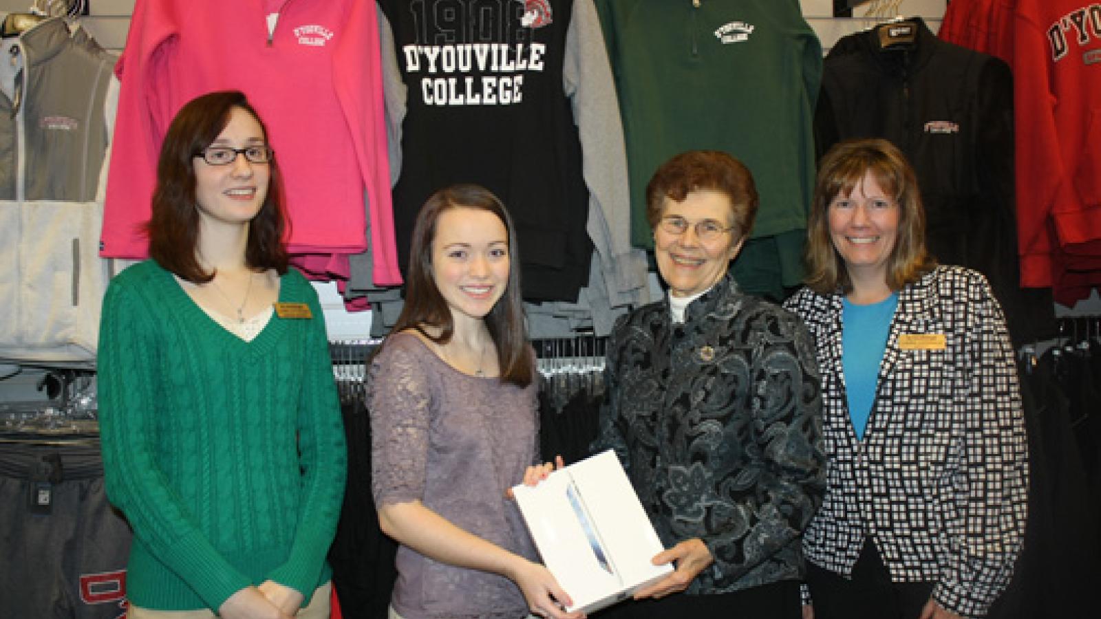 Sister Denise presenting iPad to student