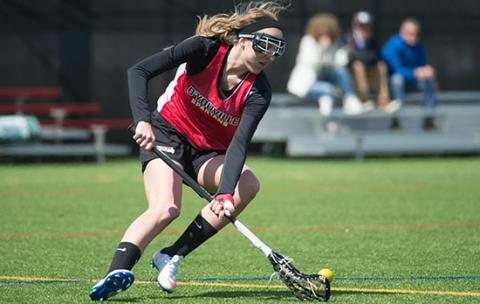 Lacrosse player on Dobson field.