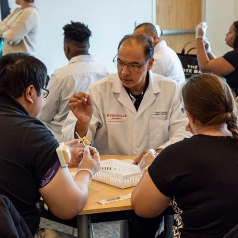 Students participating in immunization training