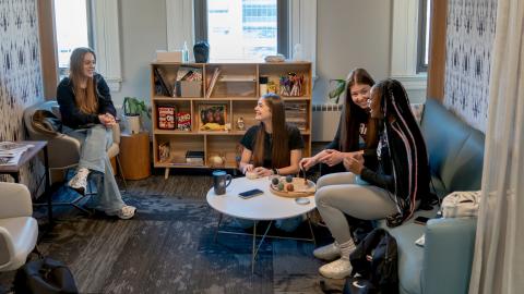 Group of students sitting in a lounge together. 