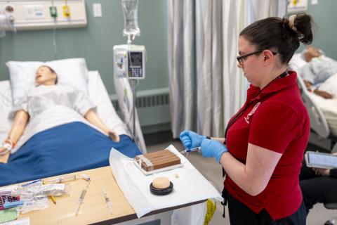 nursing student practicing IV insertion 
