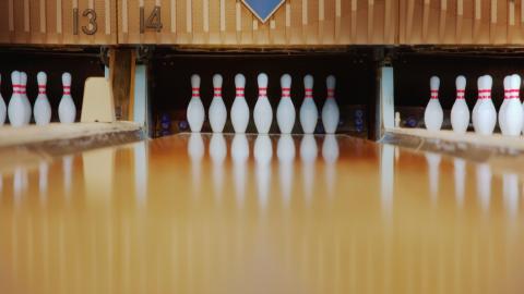 looking at the pins at the end of a bowling alley