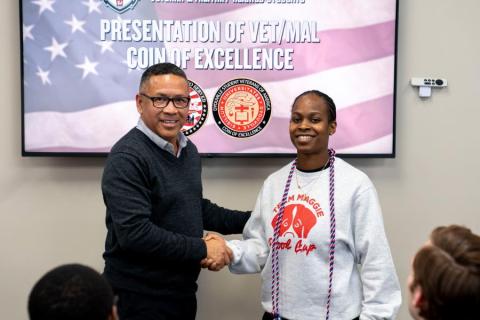 Image of Phillip Pandy at DYU at Coin Ceremony shaking hands 