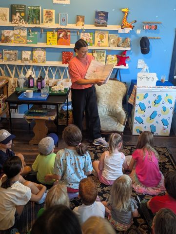 image of Dr. Liwosz reading her book to a class