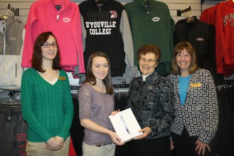 Sister Denise presenting iPad to student
