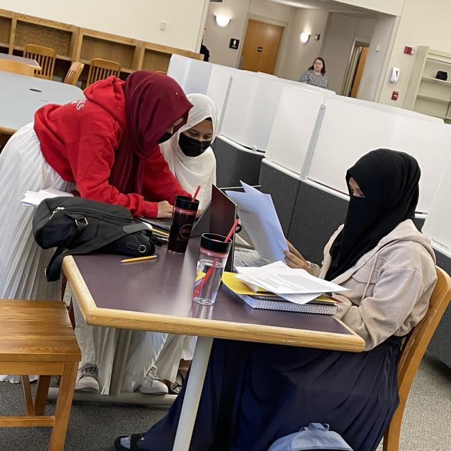 A group of young students gather to study in the montante family library