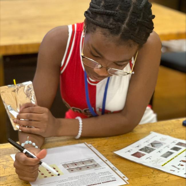 Female student reading a document in a classroom