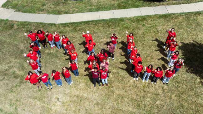 A group of students arranged to spell out DYU from above.