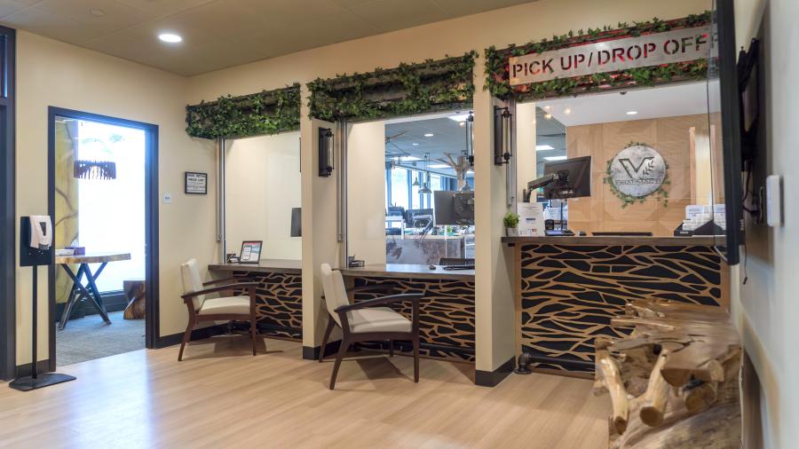 Inside the lobby of Vital Pharmacy, you see three check-out counters.