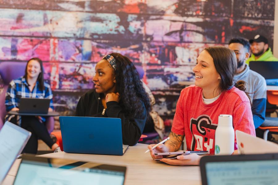 Students sit at a table during a lecture