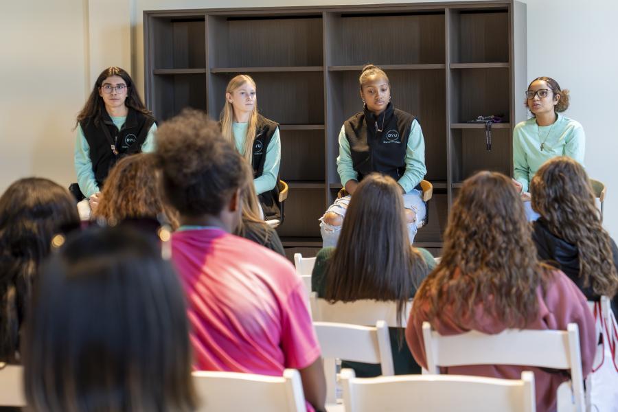 panel of four students sitting in front of an audience
