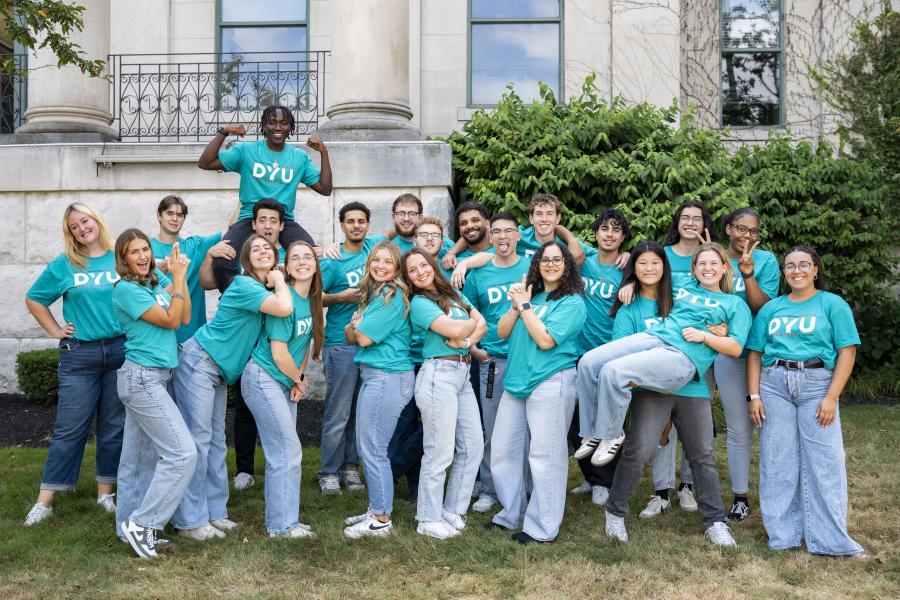 large group of students pose and smile at the camera