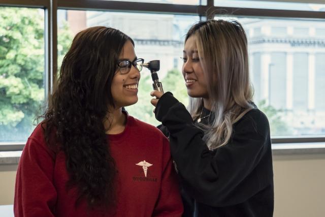 PA student with otoscope