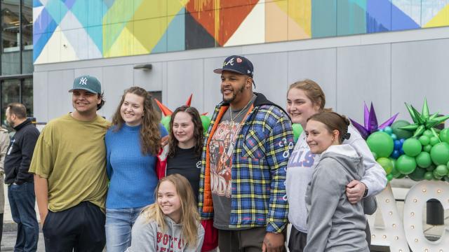 Students posing with Dion Dawkins
