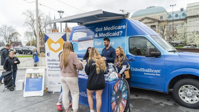 students in front of united healthcare van