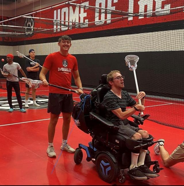 student athlete with community member in wheelchair