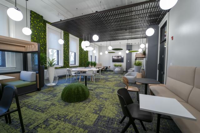The Park student lounge inside the Koessler Administration Building. Modern tables, chairs and booths, arranged in a large open room