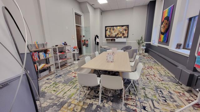 a meeting space with a large conference table in the center