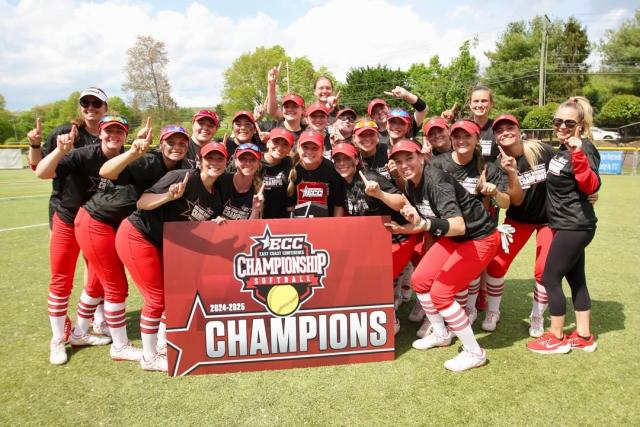 dyouville university softball team stands with banner that reads ecc softball champions
