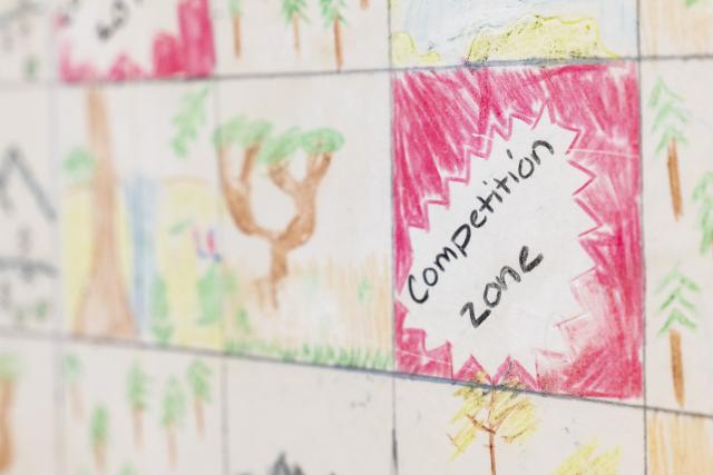 close up on a game board with squares. One reads Competition Zone.