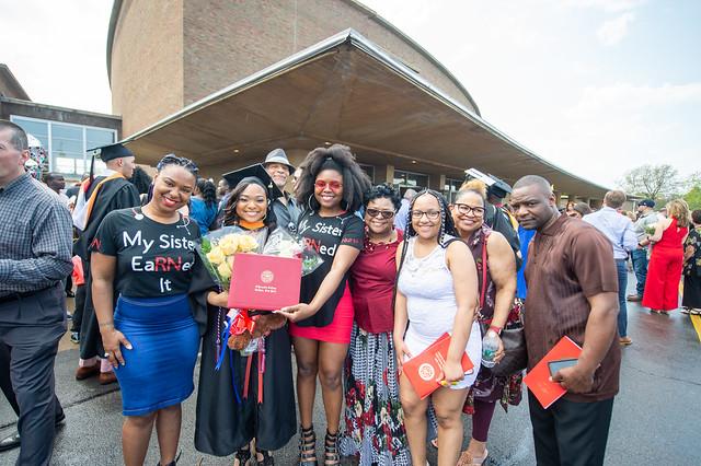 Family members pose with nursing graduate.