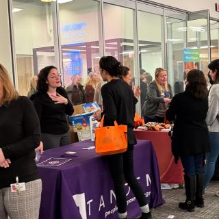 group of people talking at tables during a networking event